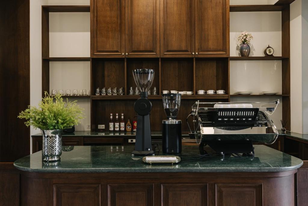 A built-in beverage station displays an espresso machine, grinders, glassware and bottles.