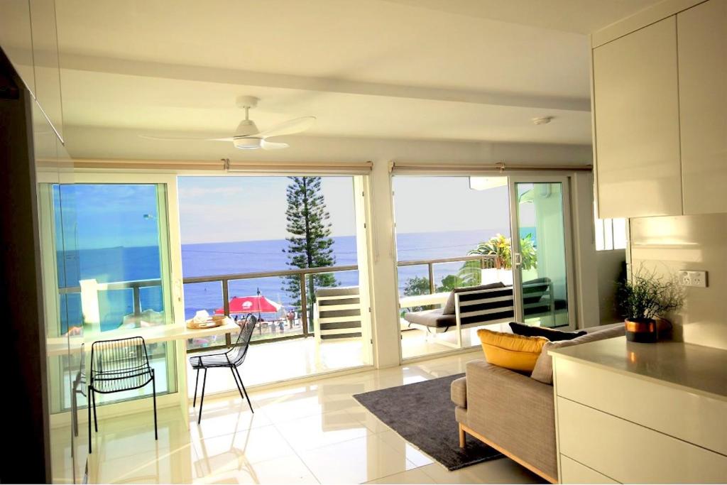 a kitchen and living room with a view of the ocean at Alexandra Headland Ocean Dream - Stunning View ZA6 in Alexandra Headland