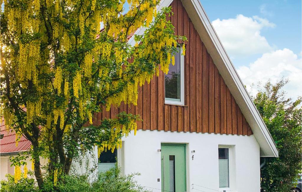 a red and white house with a tree next to it at Beautiful Home In Morschen With Wifi in Morschen