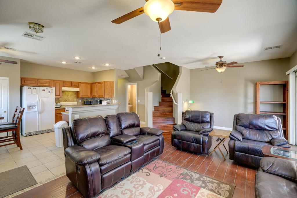 a living room with leather furniture and a kitchen at Las Vegas Vacation Rental with Pool Access in Las Vegas