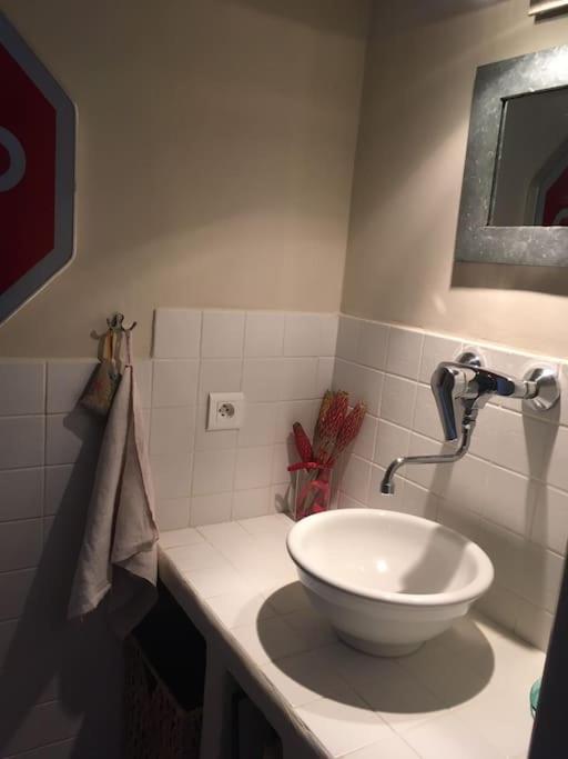 a bathroom with a white bowl sink on a counter at Gite des amis Domaine de Mas Caron in Caromb