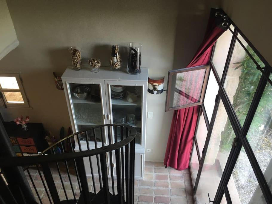 a staircase leading to a room with a cupboard at Gite des amis Domaine de Mas Caron in Caromb