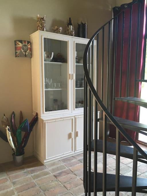 a staircase with a white hutch in a room at Gite des amis Domaine de Mas Caron in Caromb