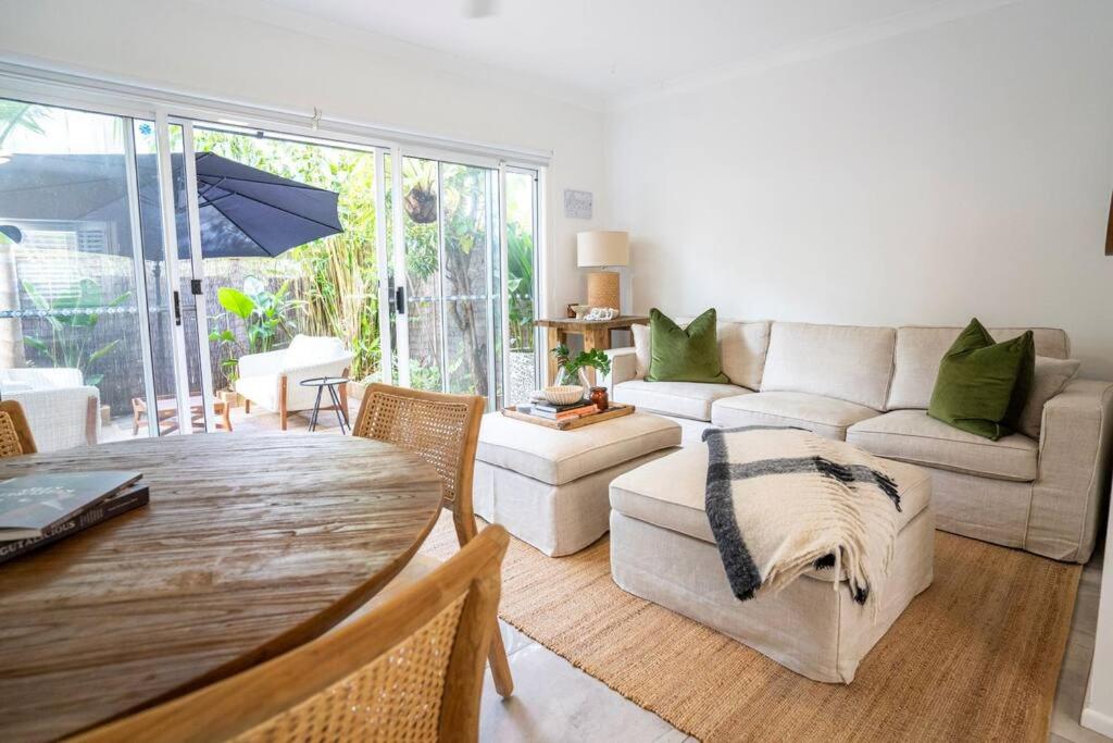 a living room with a couch and a table at Fantastic central location in Noosaville