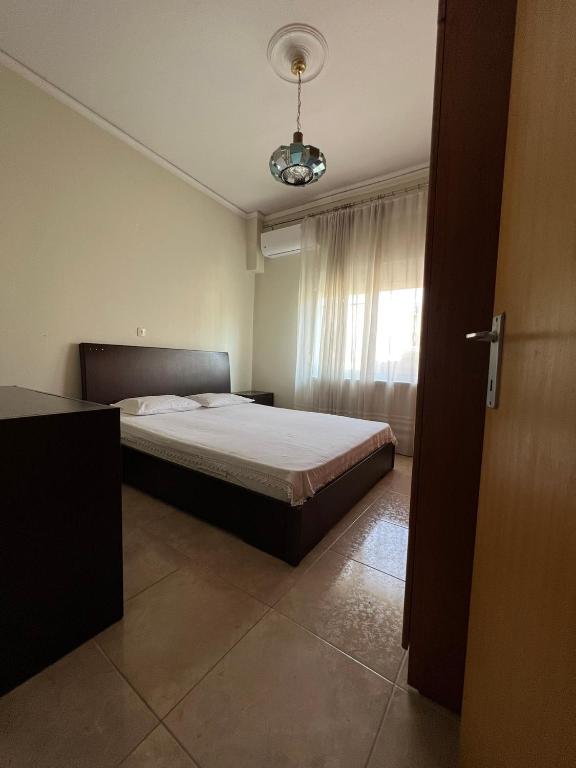 a bedroom with a bed and a window at P & P Apartment in Alexandroupoli