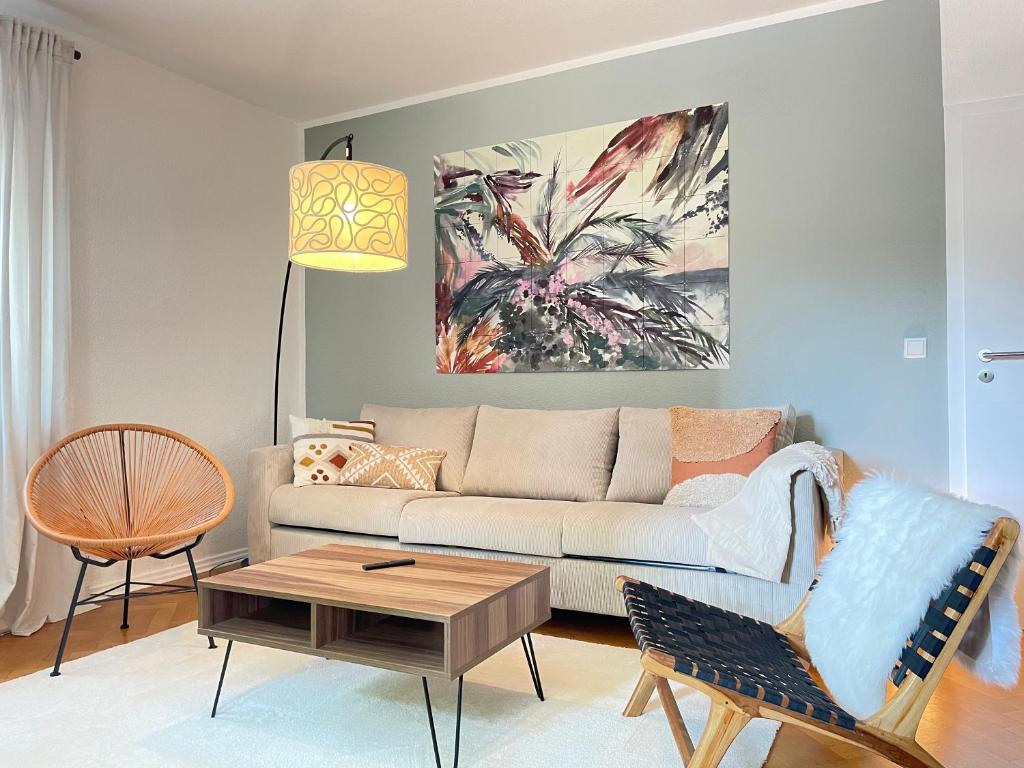 a living room with a couch and a table at Boho Style Apartment - Messe - Rüttenscheid in Essen