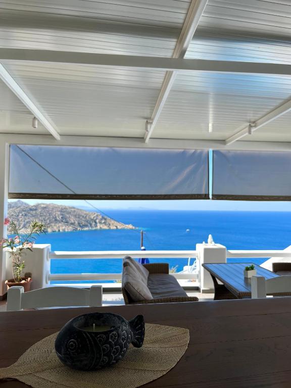 a living room with a view of the ocean at Hotel Petradi in Ios Chora
