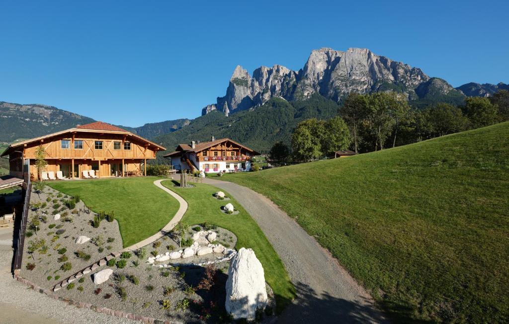 a house on a hill next to a road at Dosserhof in Völs am Schlern