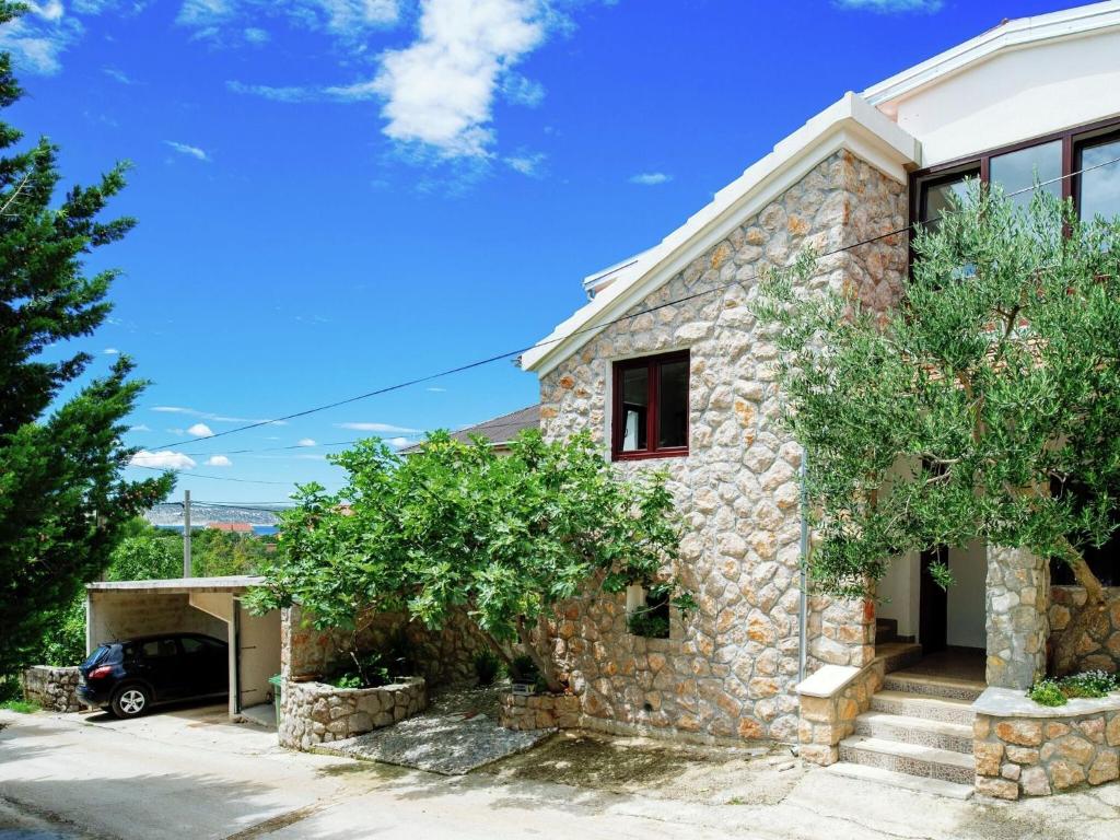 斯塔利格拉德－帕克萊尼采的住宿－Modern Apartment in Starigrad with Garden，车道上停放一辆汽车的石头房子