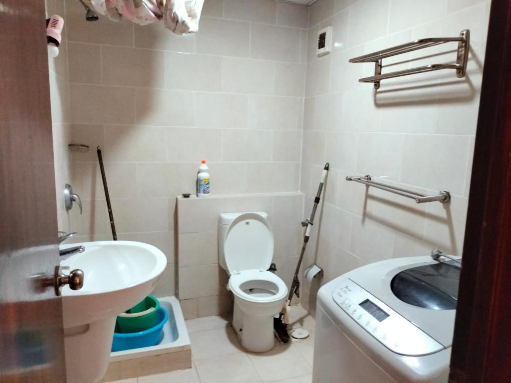 a small bathroom with a toilet and a sink at جولف بورتو مارينا in El Alamein