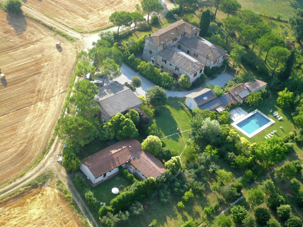 an aerial view of a large house with a yard at Chic Farmhouse in Asciano Italy with Swimming Pool in Asciano