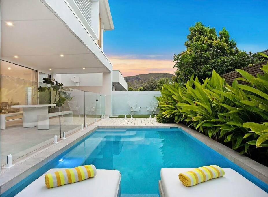 a swimming pool in the backyard of a house at Beachside, luxury resort living in Yaroomba