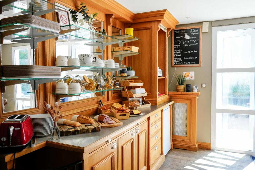 a bakery with a counter with bread and croissants at Fasthotel Reims-Taissy in Reims