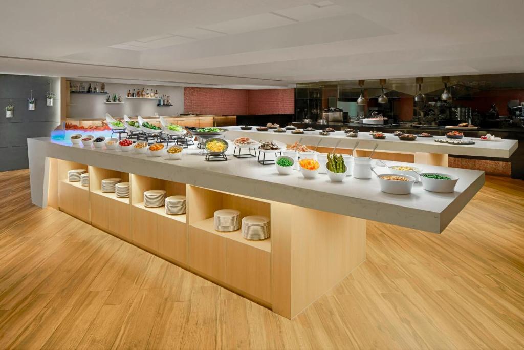 a kitchen with a buffet of food on display at Courtyard by Marriott Hong Kong in Hong Kong