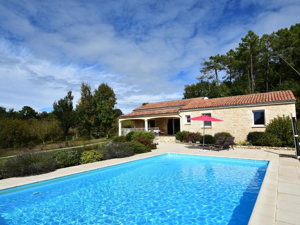 a swimming pool in front of a house at Holiday home in Montcl ra with sunny garden playground equipment and private pool in Montcléra