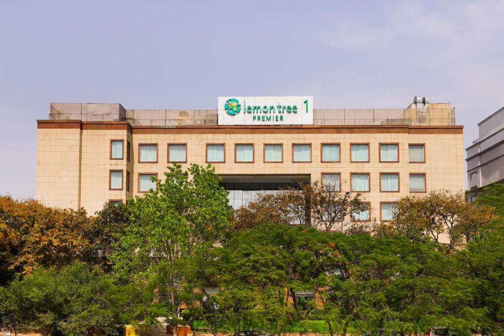 a building with a sign on the top of it at Lemon Tree Premier 1, Gurugram in Gurgaon