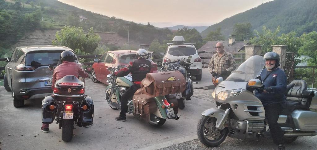 a group of people riding motorcycles on a road at Vikendica pored Drine Foča in Handići