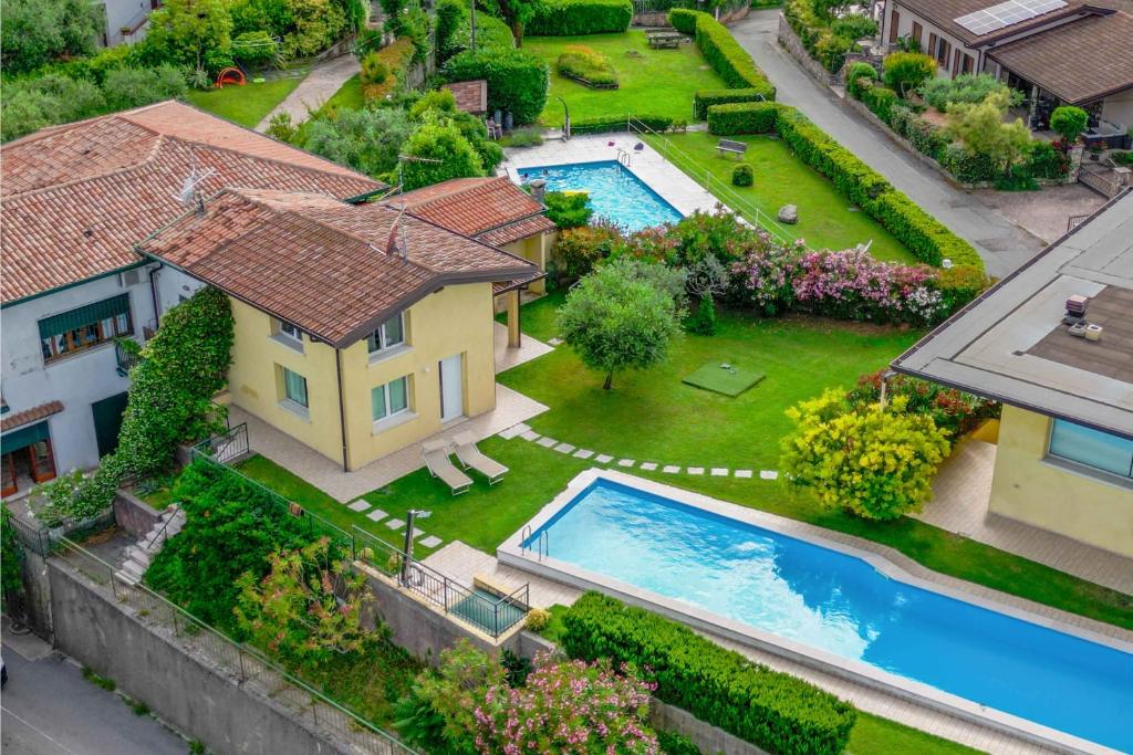 an aerial view of a house and a swimming pool at [Piscina Panoramica] - La Casa Volante in Soiano del Lago