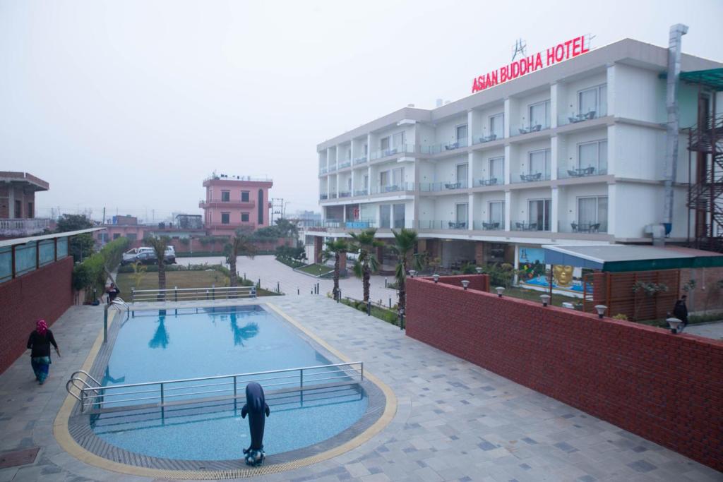 a person riding a skateboard in front of a hotel at Asian Buddha Hotel in Bhairāhawā