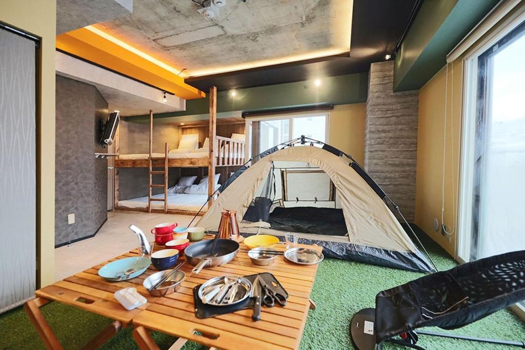 a room with a tent and a wooden table at Lions Mansion Sanbankan Room 506 - Vacation STAY 14364 in Jozankei