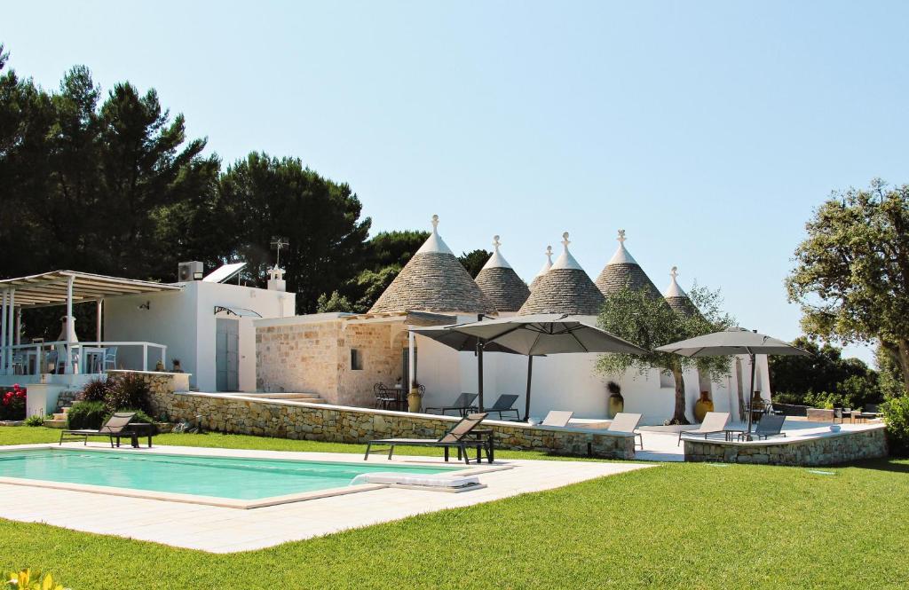 a villa with a swimming pool and a house at Relais I Secolari in Selva di Fasano