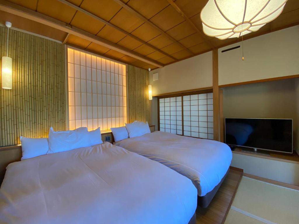 Postel nebo postele na pokoji v ubytování Kaiseki Ryokan Ashikari