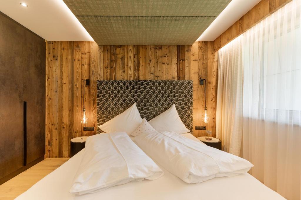 Postel nebo postele na pokoji v ubytování Hotel Garni Jagdhof