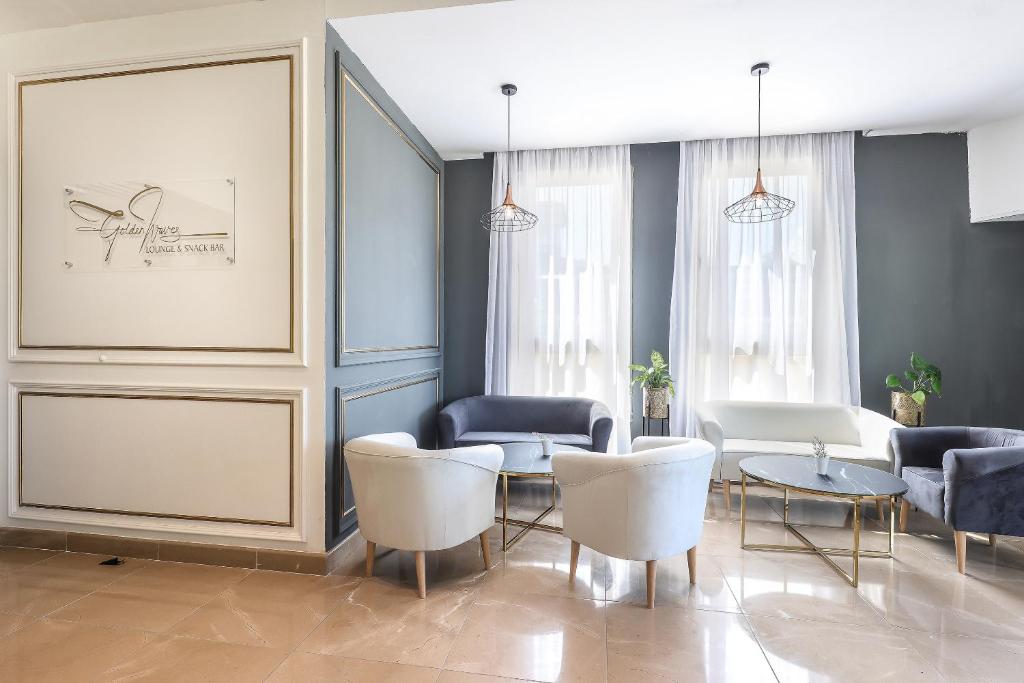 a living room with a table and chairs at Blue Waves Resort in Malinska