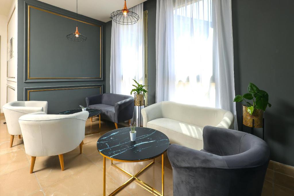 a living room with couches and chairs and a table at Blue Waves Resort in Malinska