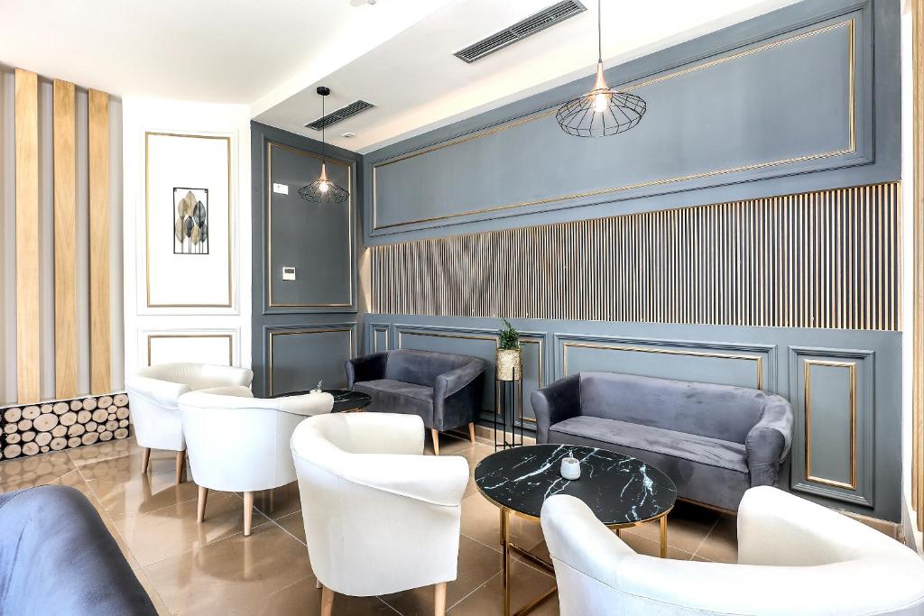 a room with couches and a table and chairs at Blue Waves Resort in Malinska