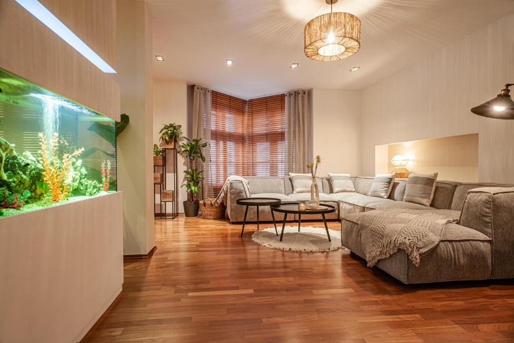 a living room with a couch and an aquarium at STING Boutique Apartments in Ostrava