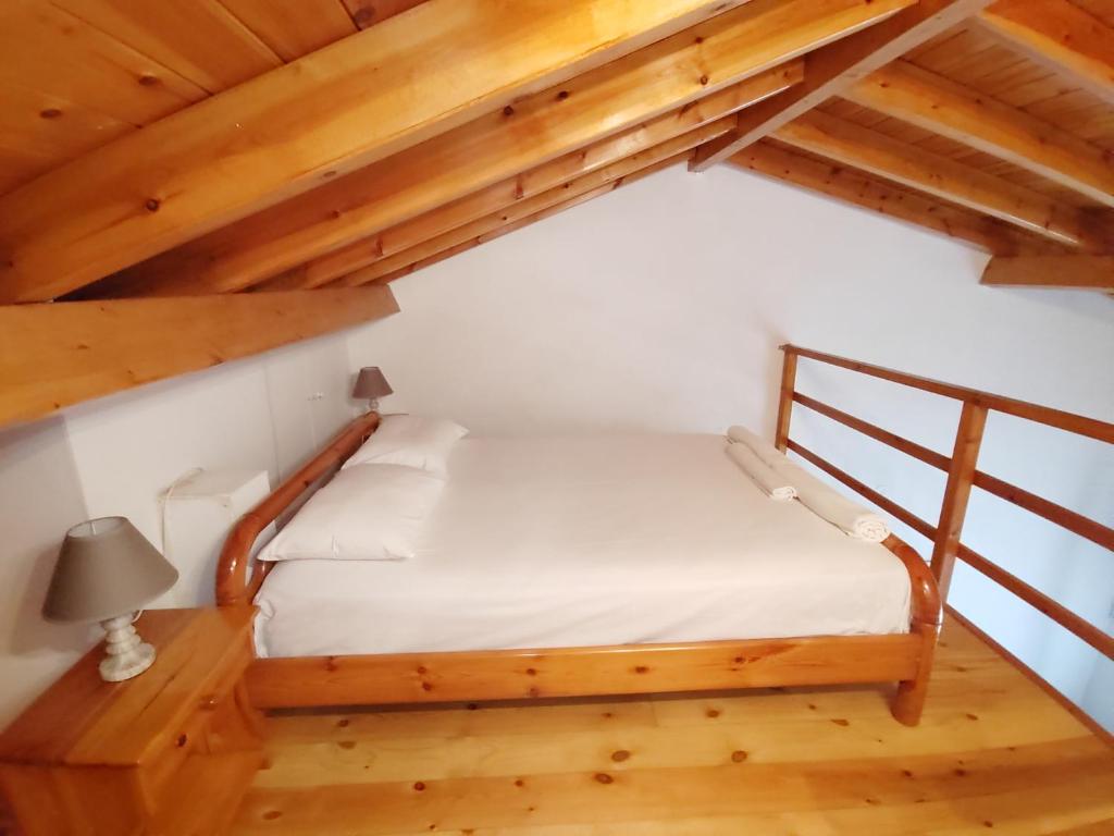 a bedroom with a bed in a attic at Olive Garden Loft Apartment in Kokkari