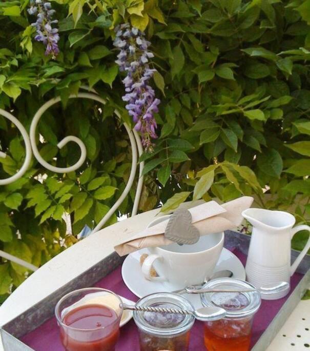 a tray with a cup of tea and spoons on it at Gîte de la corgette in Saint-Romain