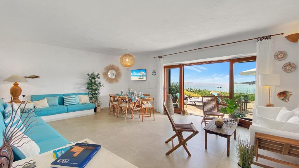 a living room with a blue couch and a table at La Maranita Apartment in La Maddalena