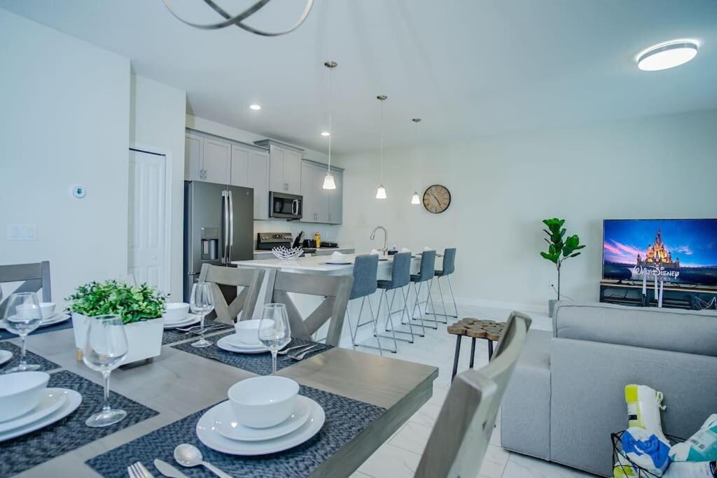 a kitchen and living room with a table and a dining room at Comfy Home with Private Heated Pool BBQ Grill in Kissimmee