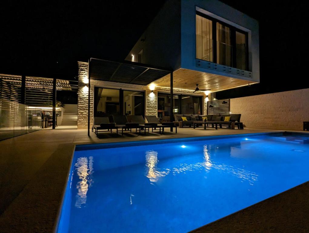 ein Schwimmbad vor einem Haus in der Nacht in der Unterkunft Villa Vinisce View in Vinišće
