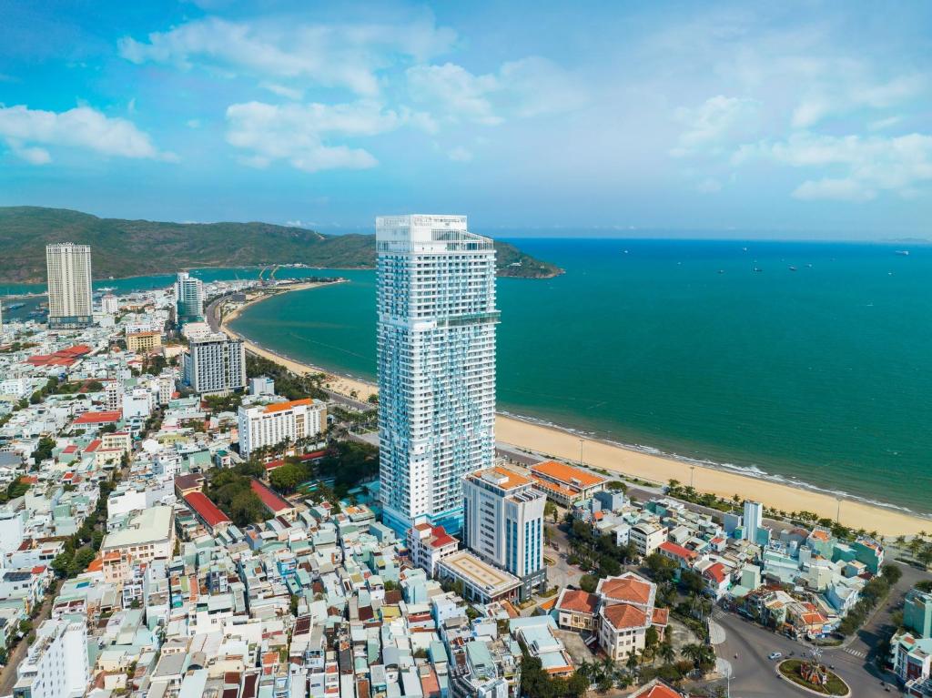 - une vue aérienne sur la plage et un grand bâtiment dans l'établissement TMS Beachfront Apartment Quy Nhon Bay, à Quy Nhơn
