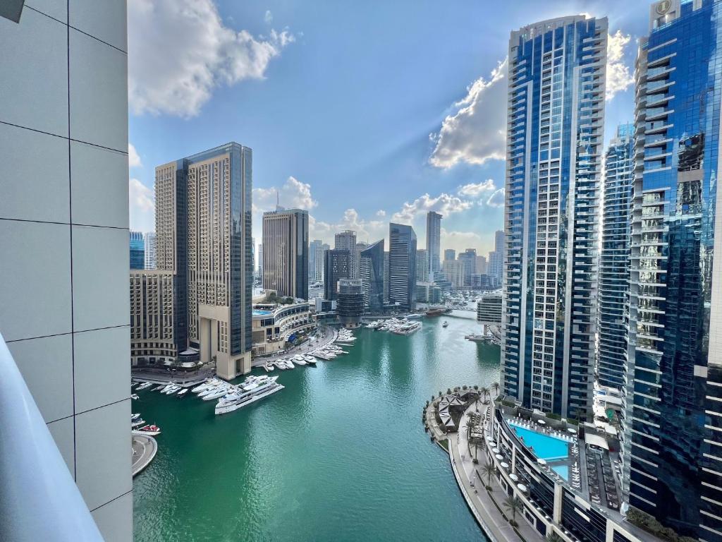a view of a river in a city with boats at Dubai Marina Continental tower in Dubai