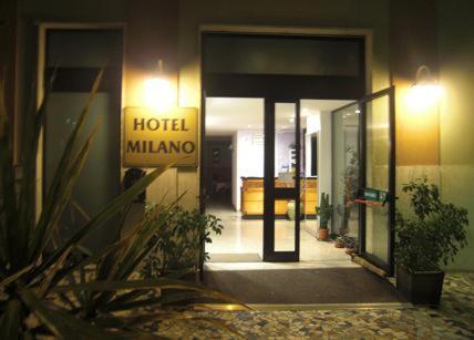 a hotel building with a sign on the door at HOTEL MILANO in Loano