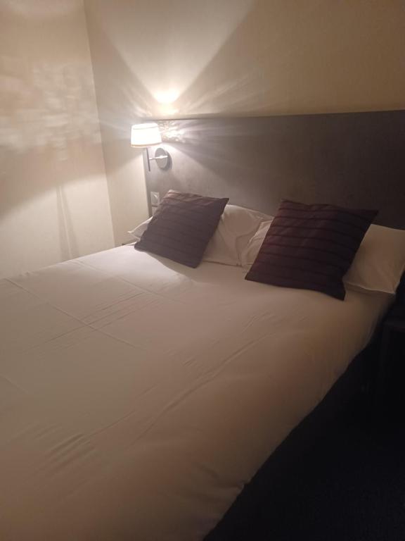 Postel nebo postele na pokoji v ubytování Hôtel La Parenthèse