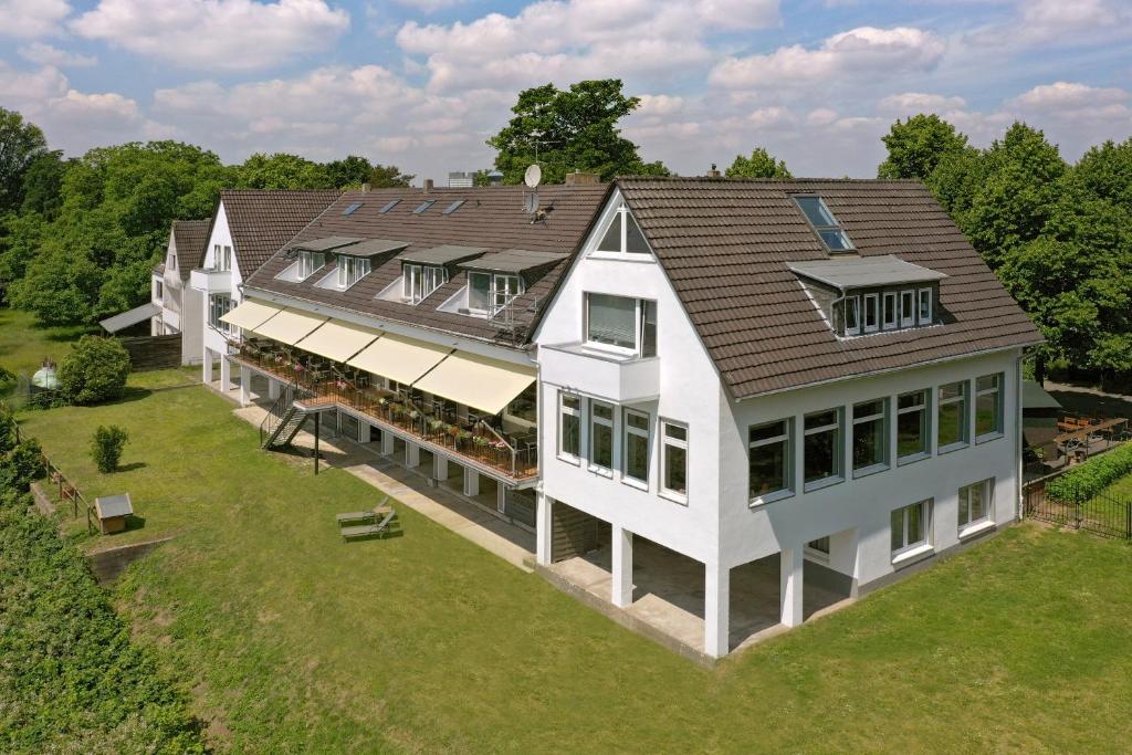 an overhead view of a large white house at Hotel Fährhaus km734 in Düsseldorf