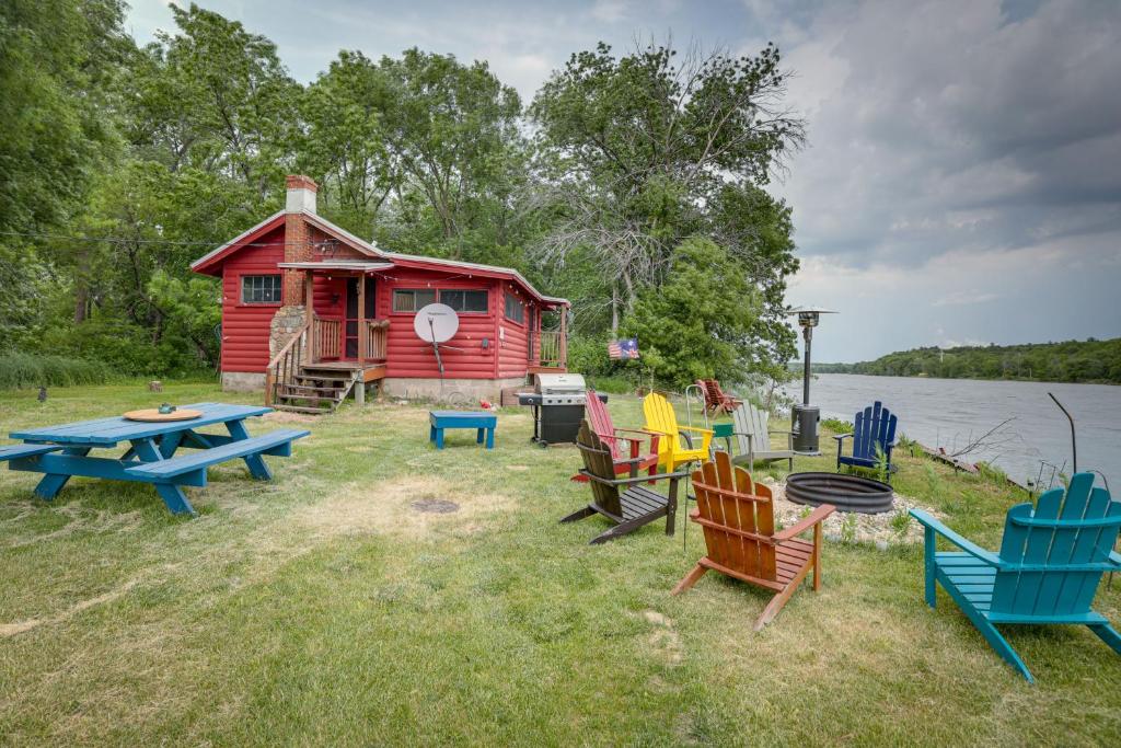 a group of chairs and a picnic table and a house at Rock River Hideaway on Private 5-Acre Island! in Oregon