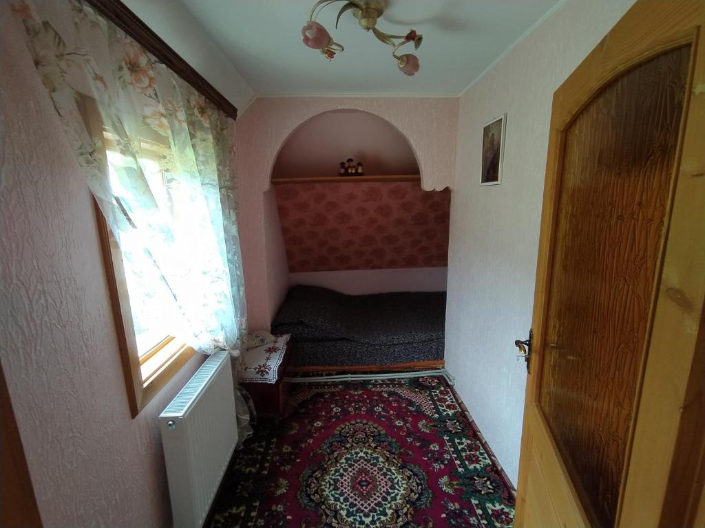 Postel nebo postele na pokoji v ubytování Гостьовий будинок