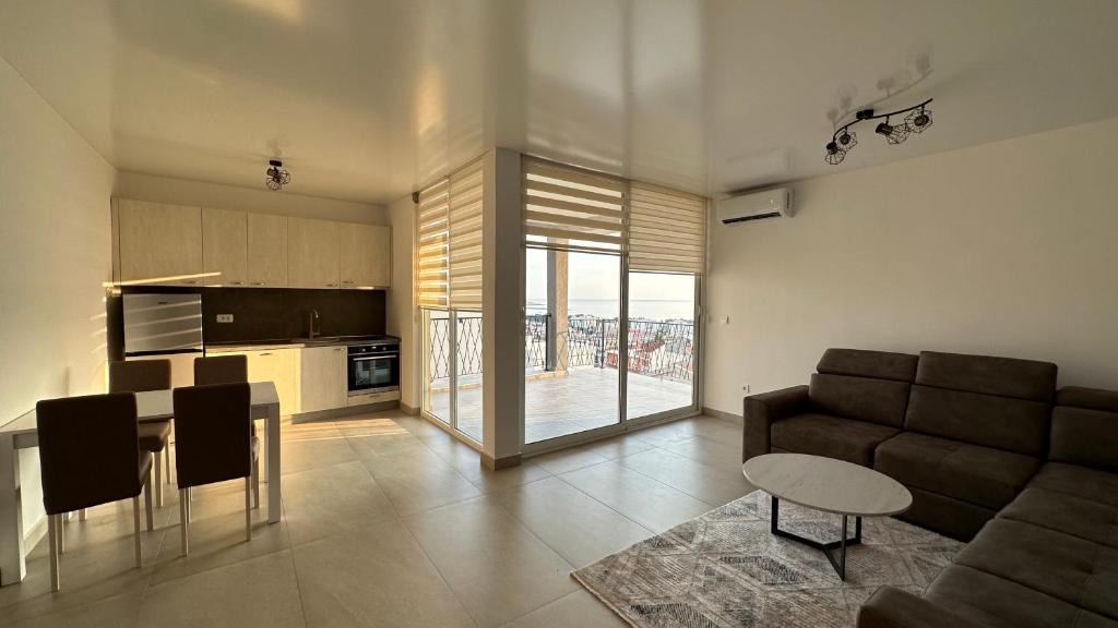 a kitchen and living room with a couch and a table at Akapulco Apartments in Bar