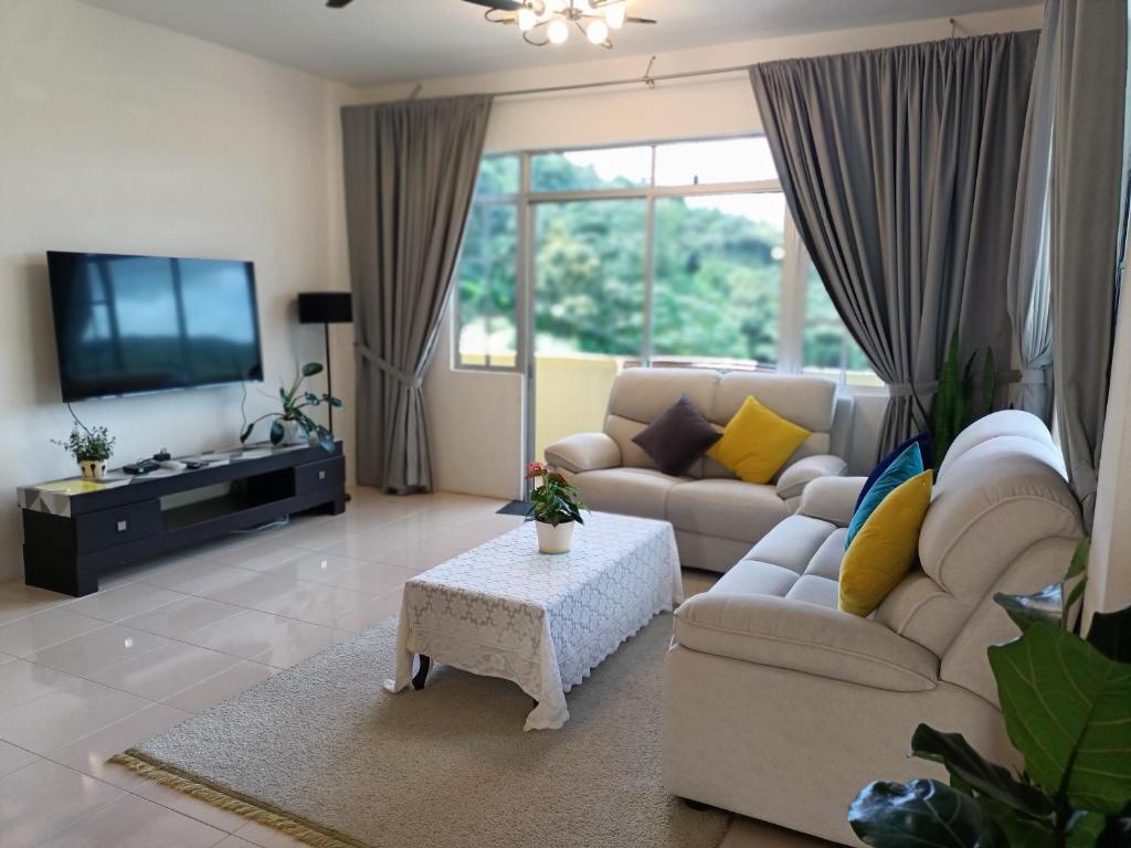 a living room with a couch and a tv at Dream 1 in Cameron Highlands