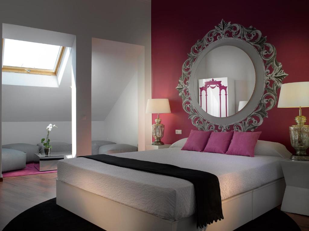 a bedroom with a large bed and a mirror at Marquis Portago in Granada