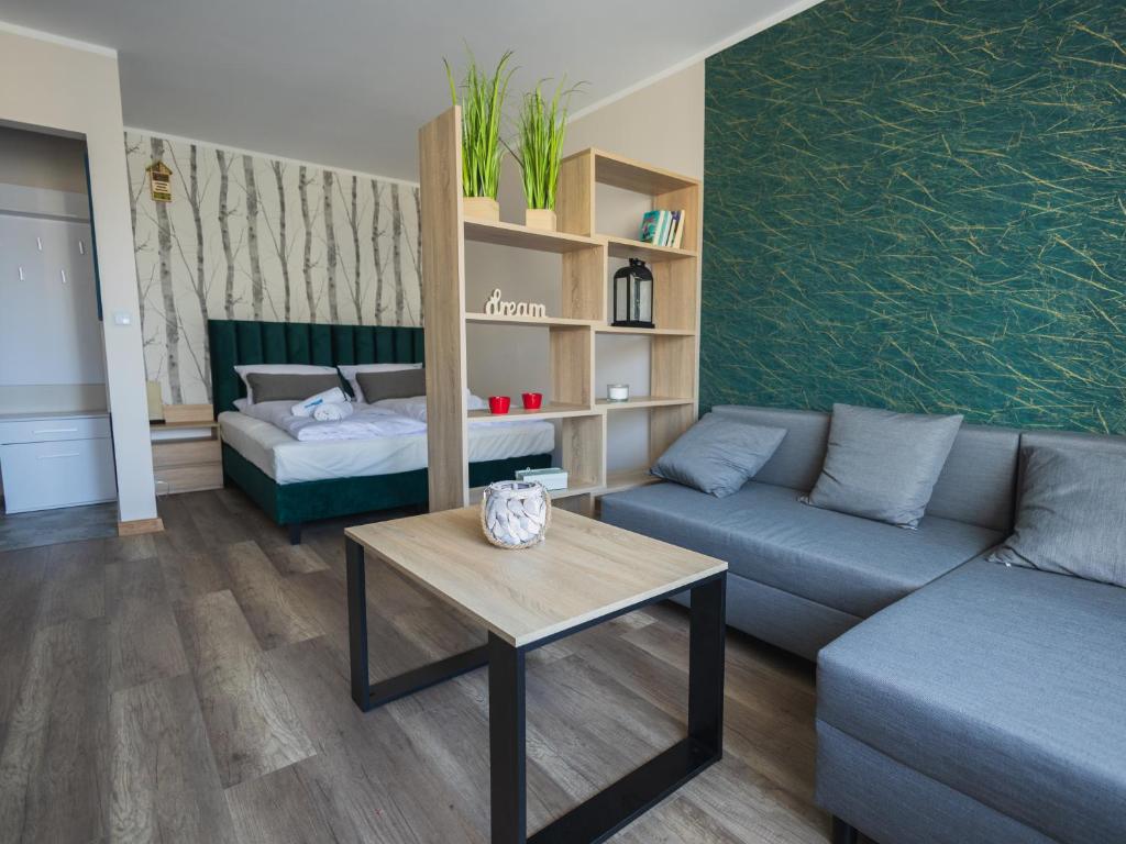 a living room with a couch and a table at Dream Team Bocianowo in Bydgoszcz