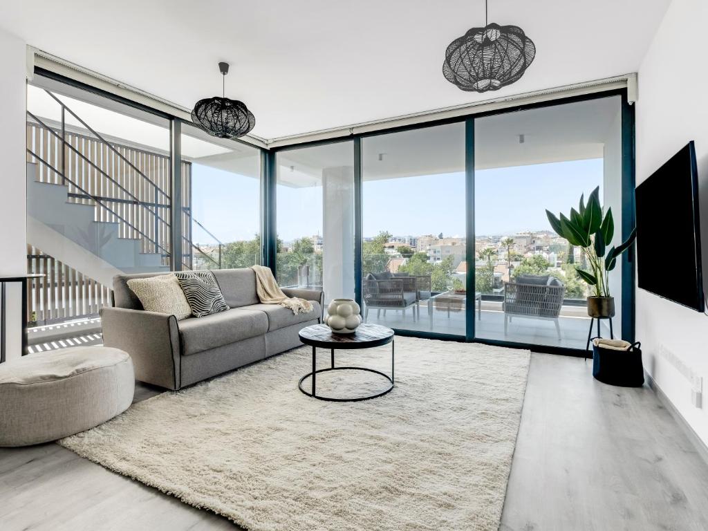a living room with a couch and a table at Sanders Park Central Residences in Limassol