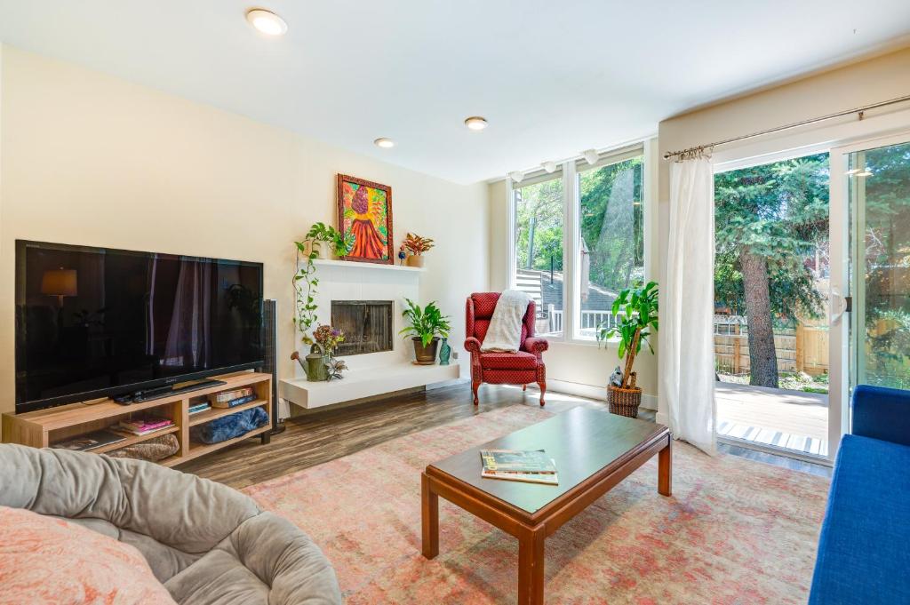 a living room with a couch and a tv at Beautiful Boulder Townhome Walk to CU and Pearl St! in Boulder