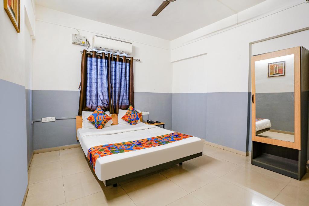 A bed or beds in a room at FabHotel Bhakti Sankul